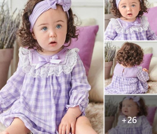 Elegance Personified: The Captivating Toddler with Enchanting Flowing Curls in Shades of Purple